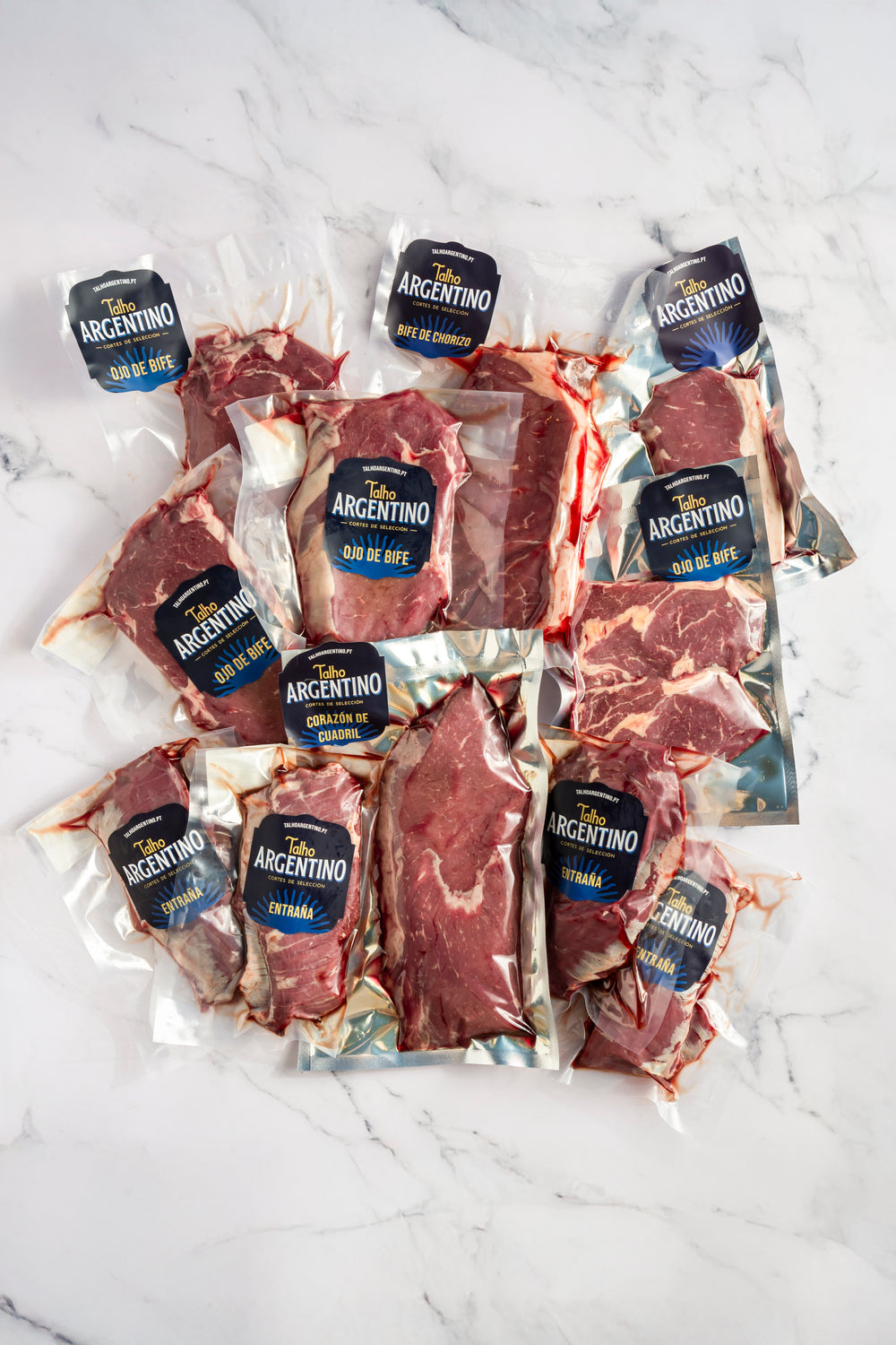 Vacuum-packed cuts of meat with their labels, seen from above